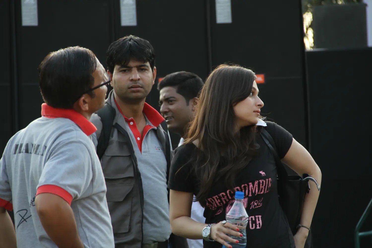 Man and woman speaking on stage at night with blue lighting
